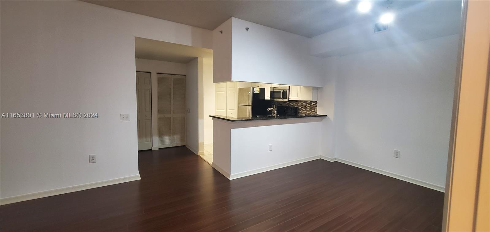 a kitchen with a sink and a stove top oven