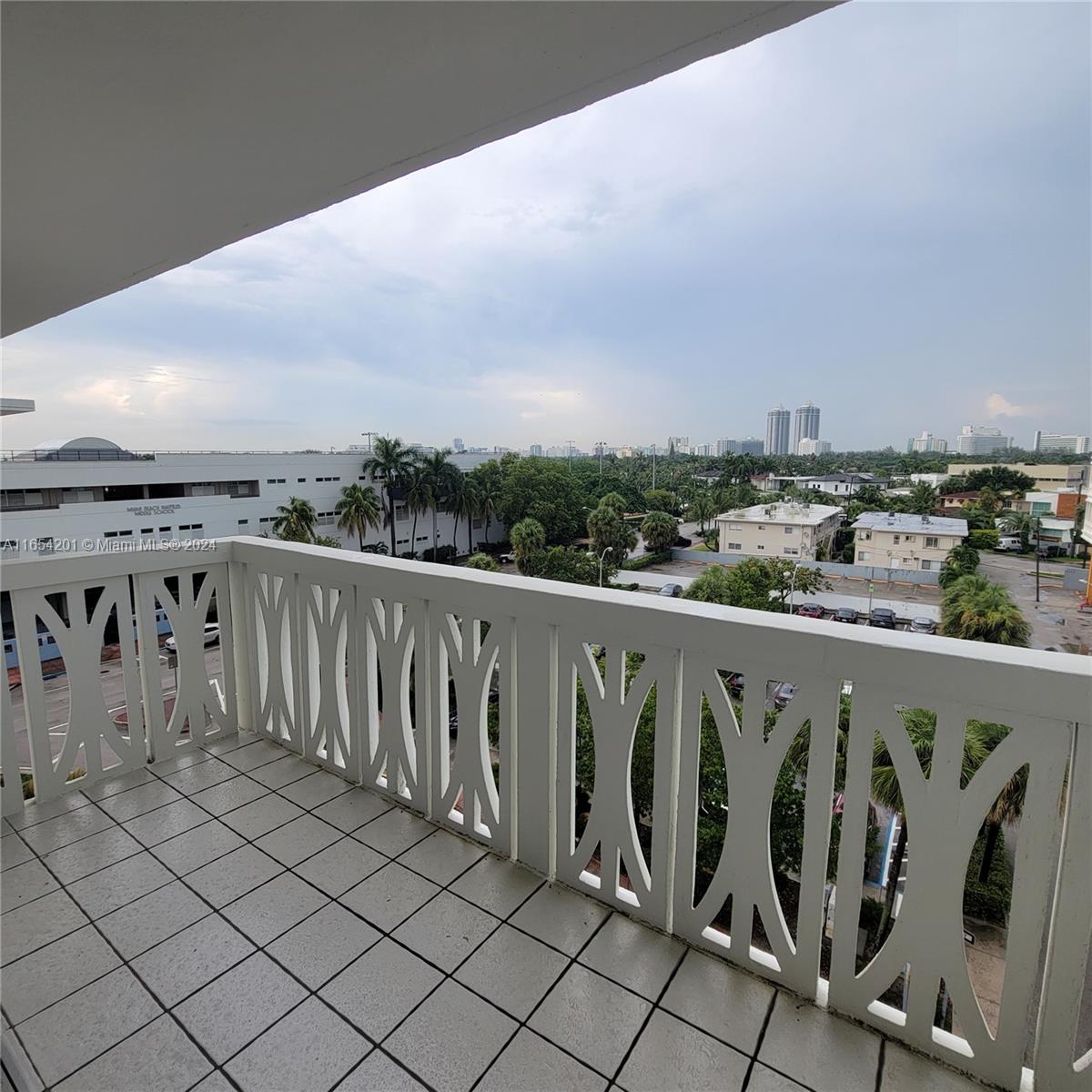 a view of a balcony with wooden fence