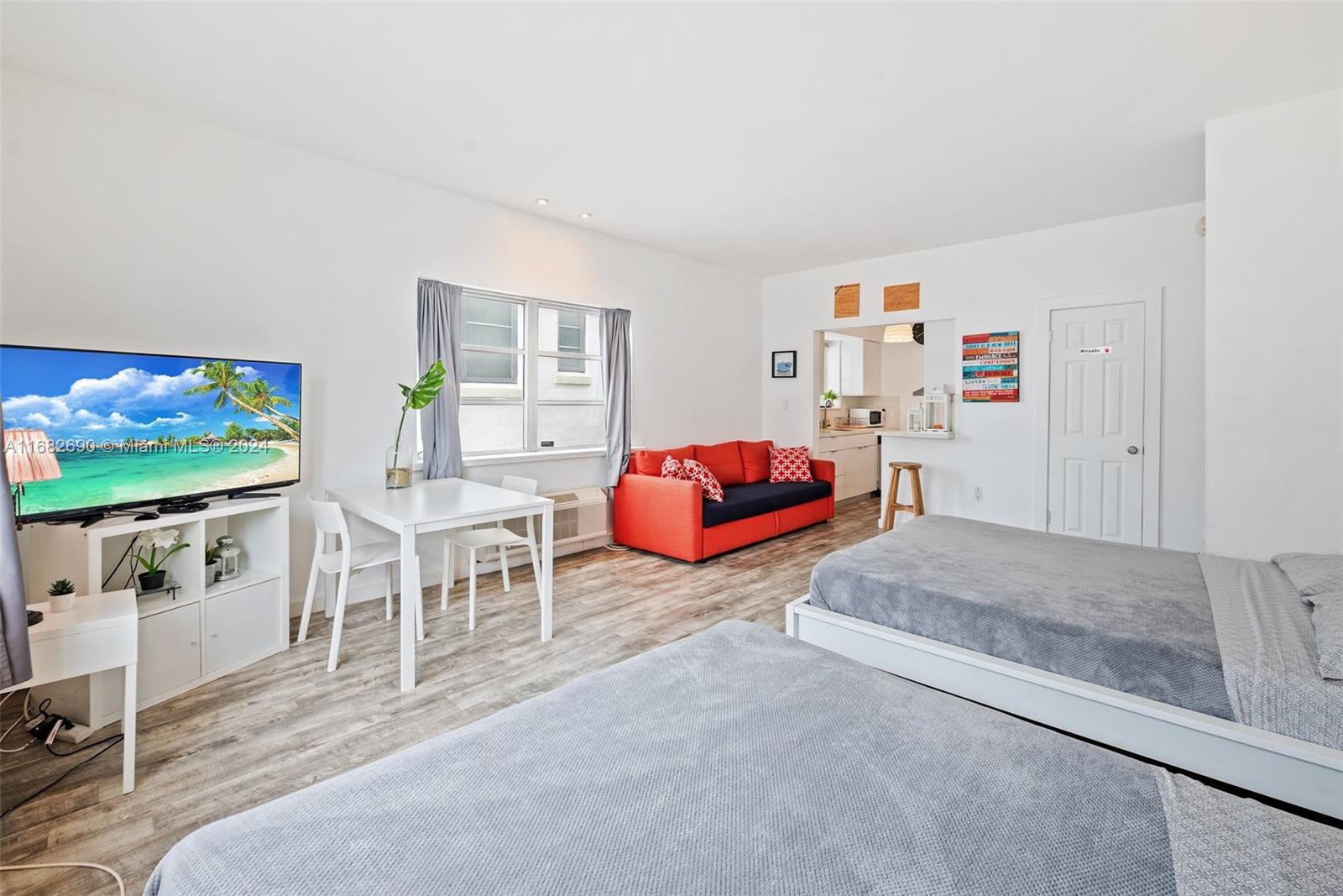 a bedroom with furniture and a flat screen tv