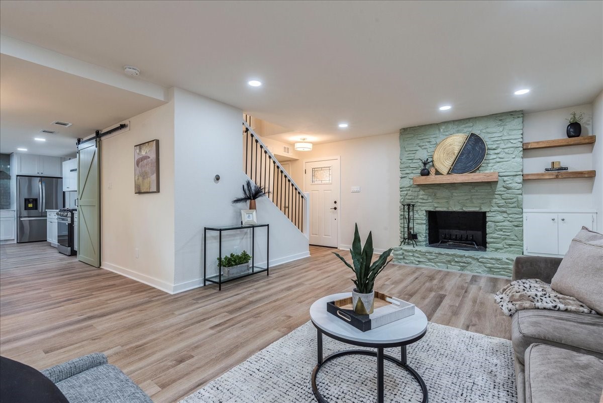 a living room with furniture and a wooden floor