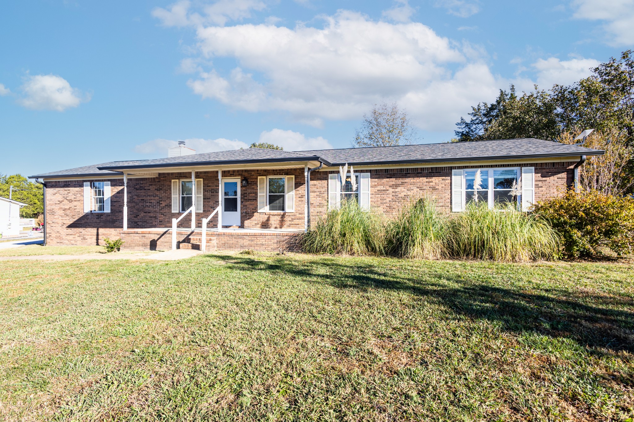 a front view of house with yard having outdoor seating