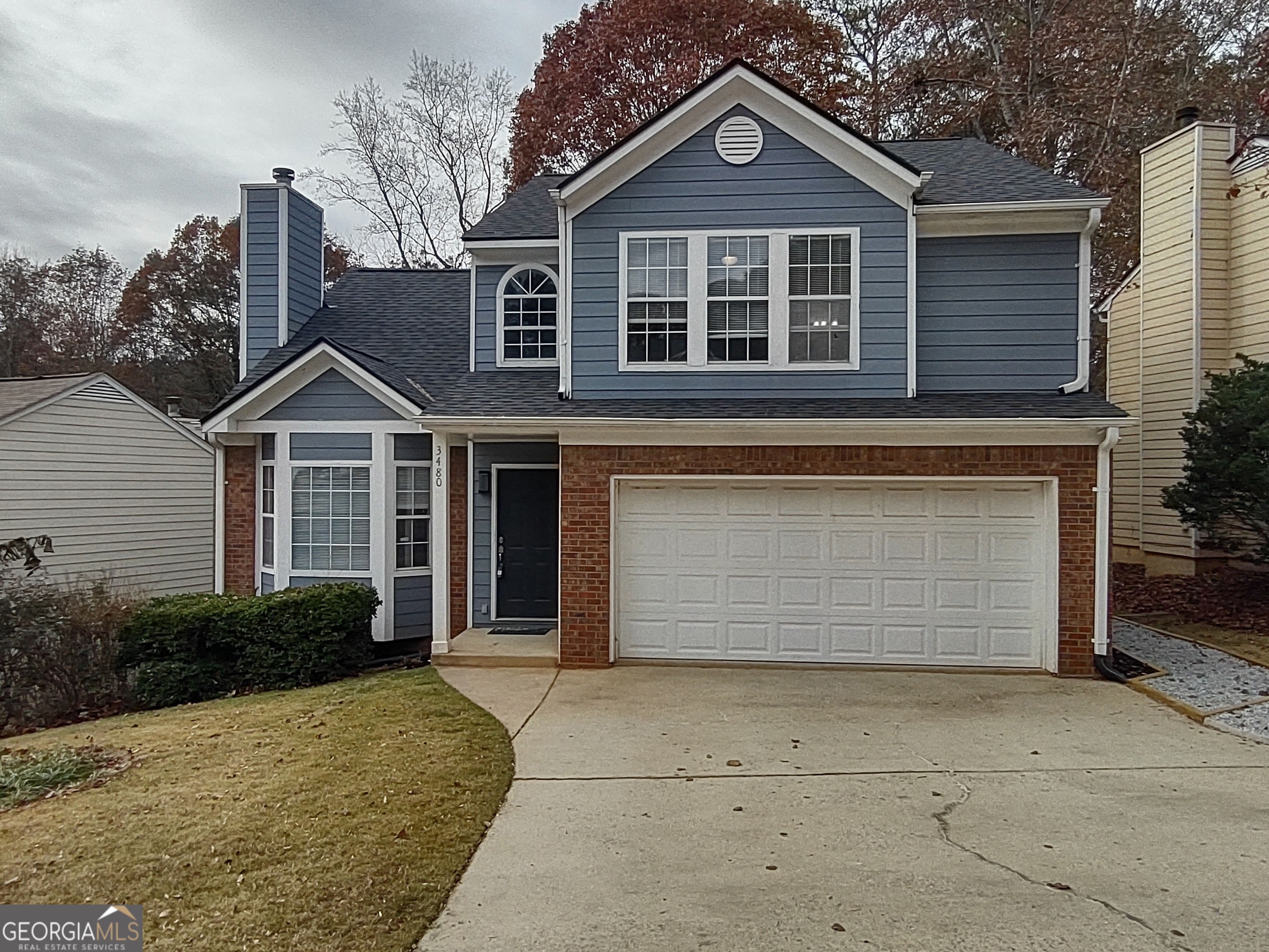 a front view of a house with a yard and garage