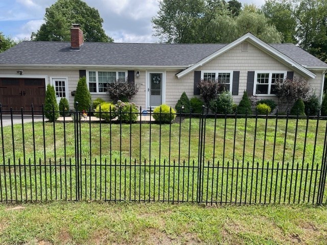 a front view of a house with a garden and plants