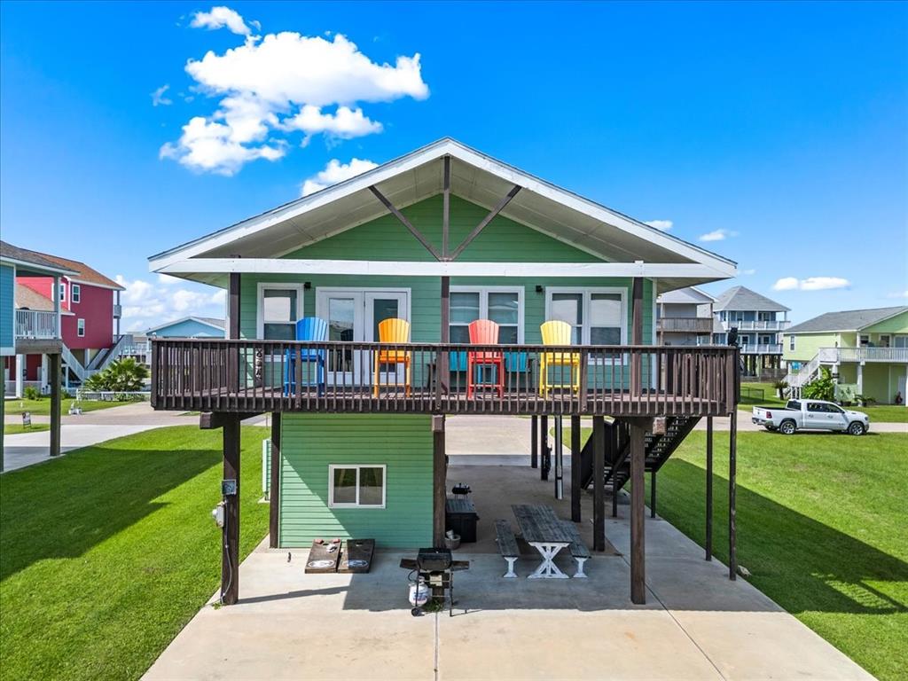 a view of a house with a yard patio and a slide