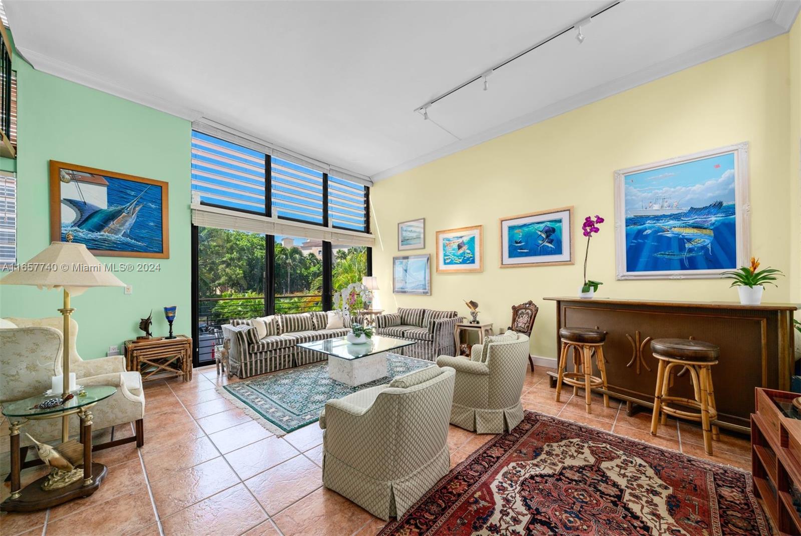 a living room with furniture a rug and a large window