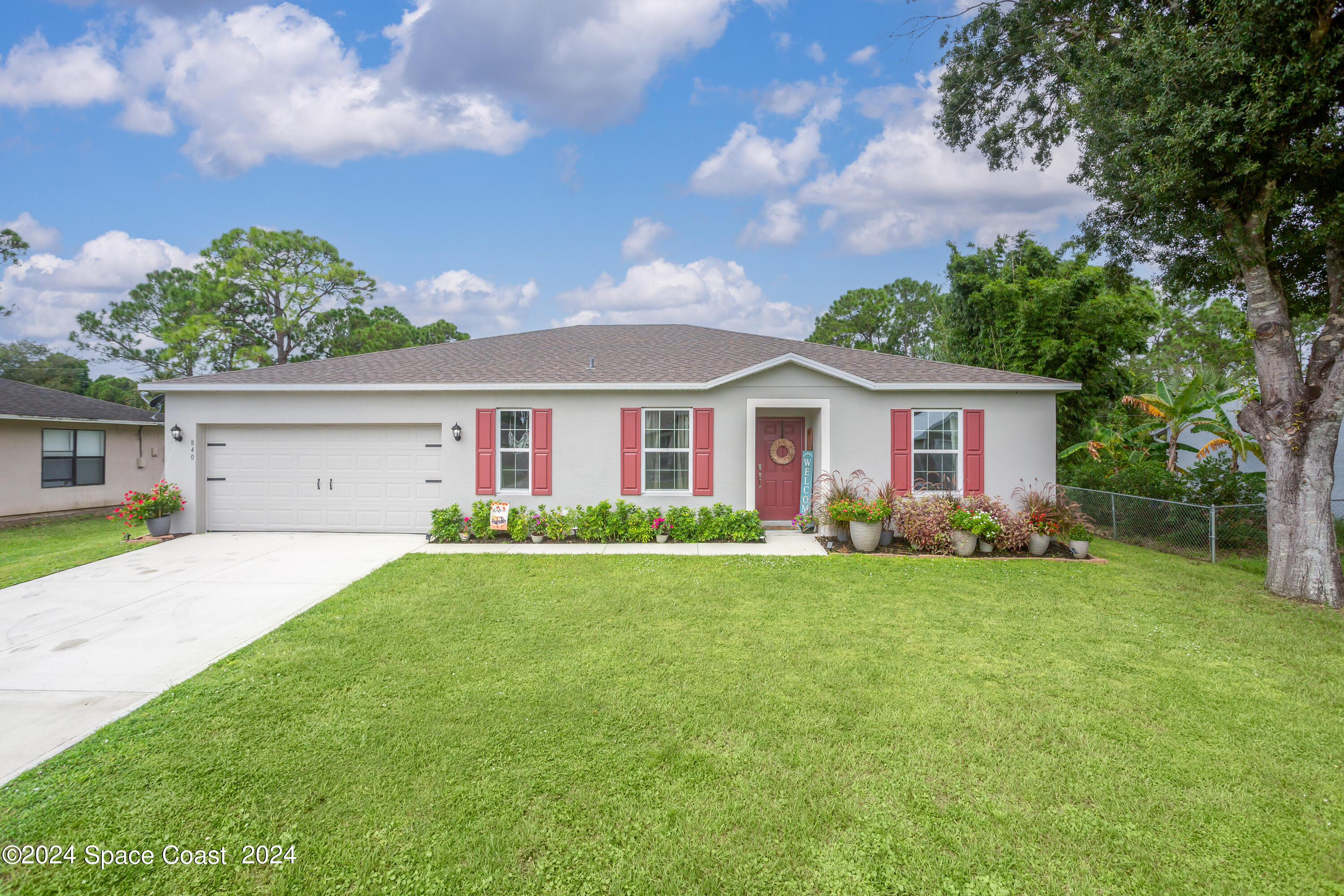 a front view of house with yard and green space