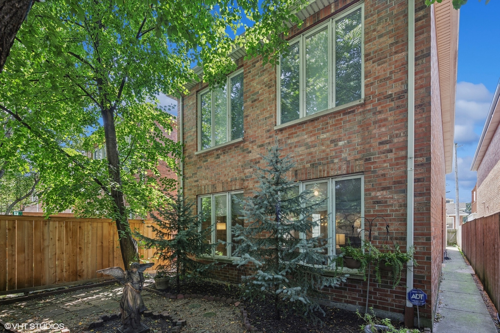 a view of a brick house with a tree in front of it