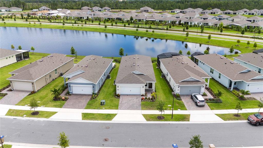 an aerial view of a house with a swimming pool yard and outdoor seating