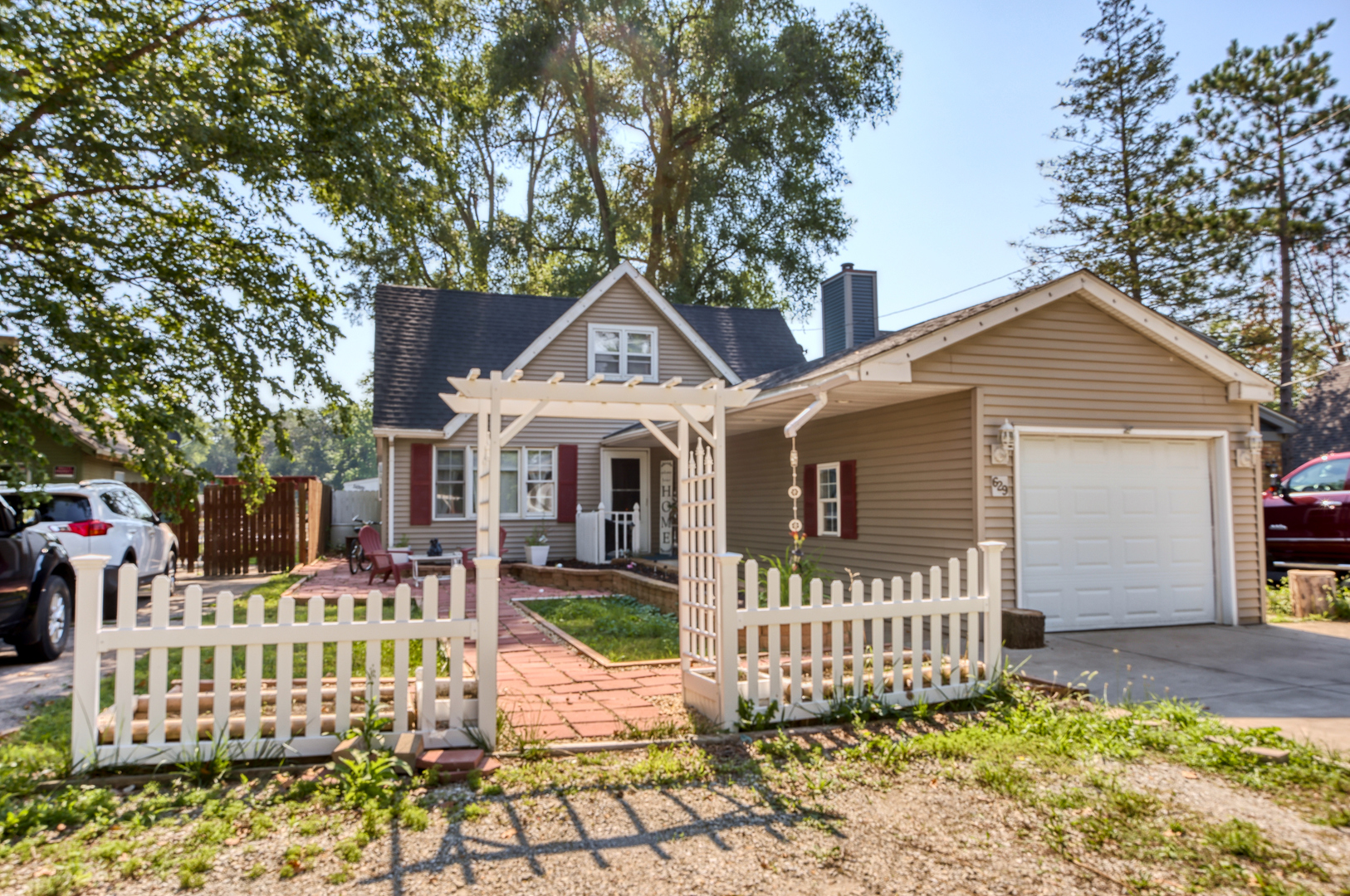 a front view of a house with a garden