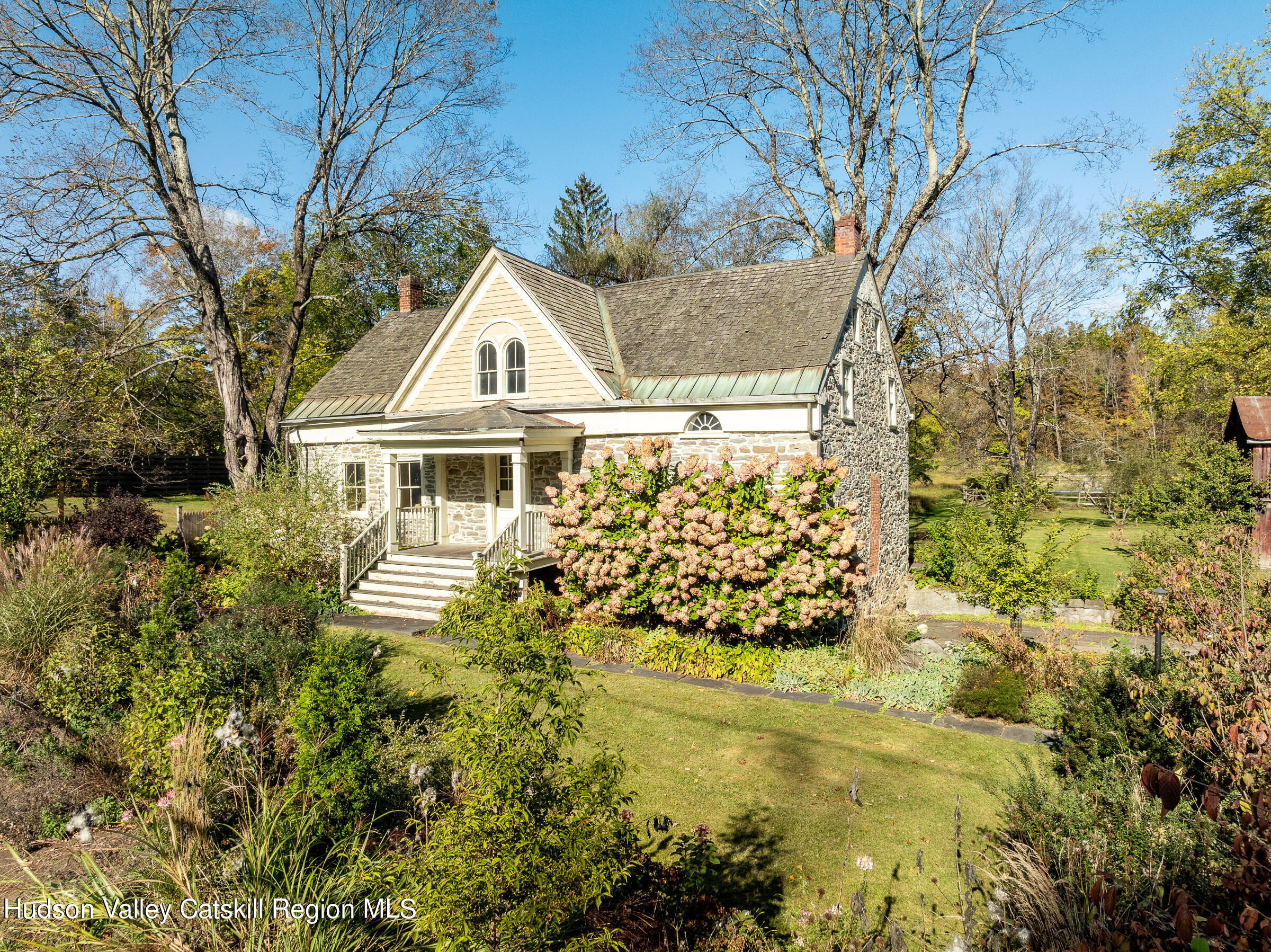 a front view of house with outdoor space and trees around