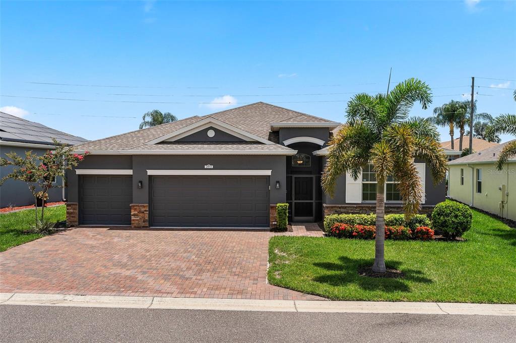 a front view of a house with a yard and garage