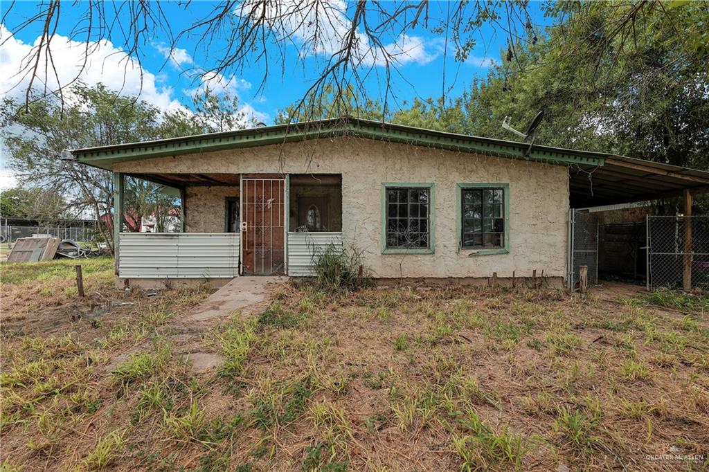 a house with a tree in the grass