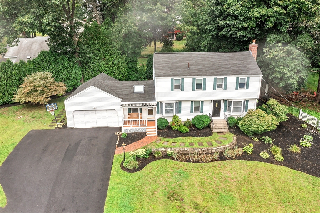 a front view of a house with yard and green space