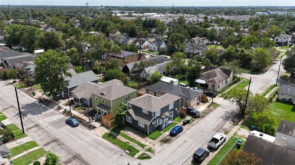 an aerial view of multiple houses with yard