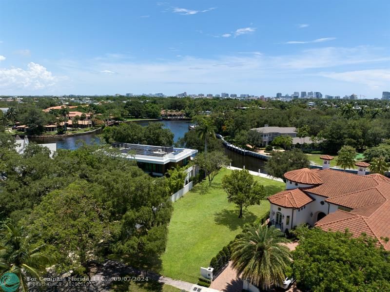 a view of a lake with houses in back