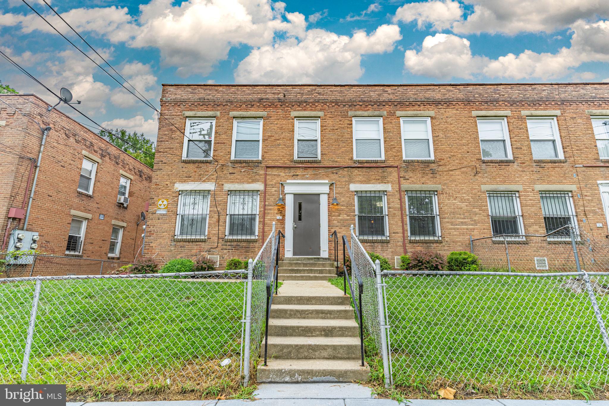 a front view of a residential apartment building with a yard