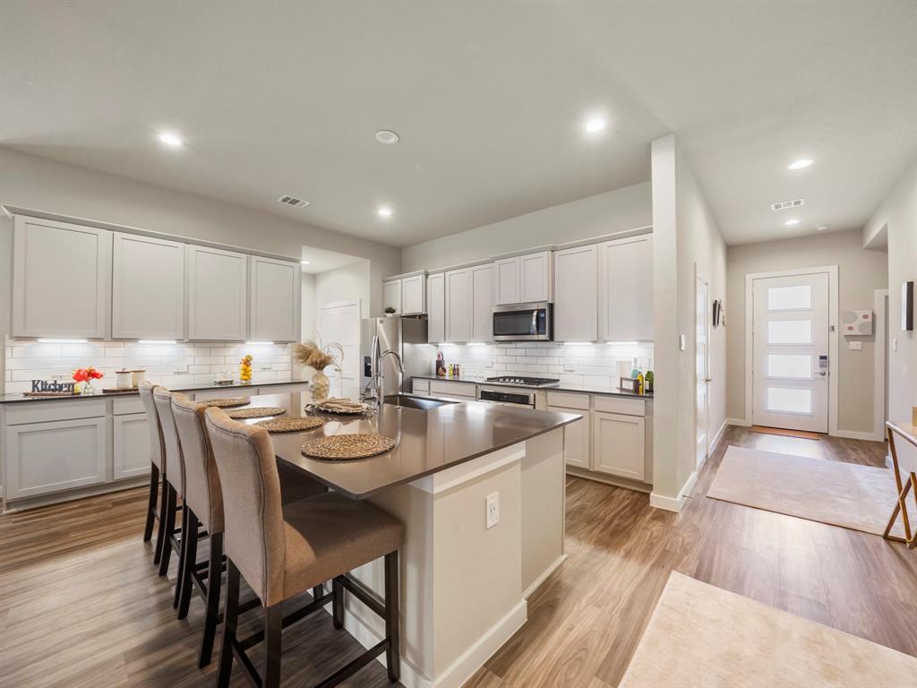 a kitchen with stainless steel appliances kitchen island granite countertop a sink and cabinets