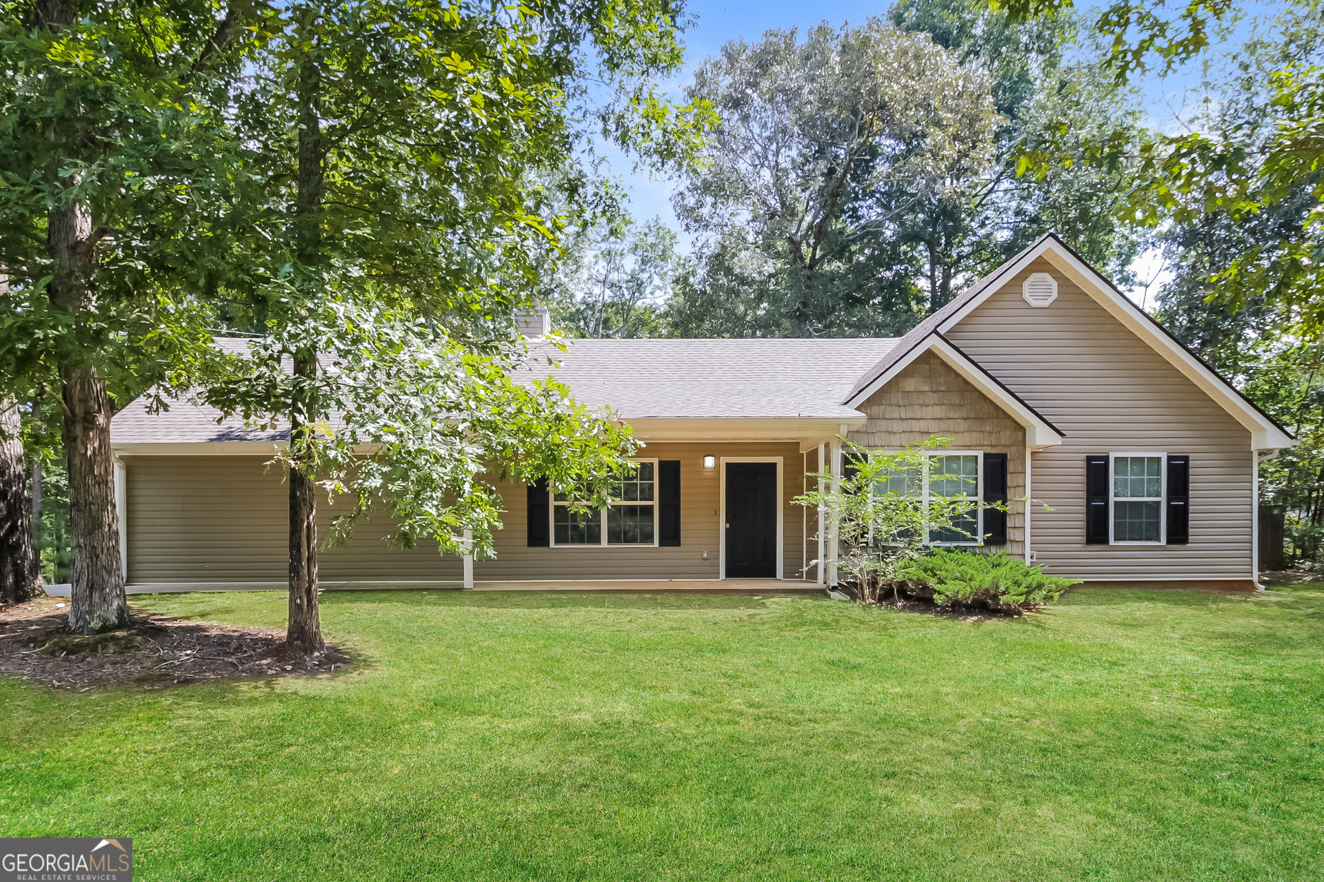 a front view of house with yard and green space