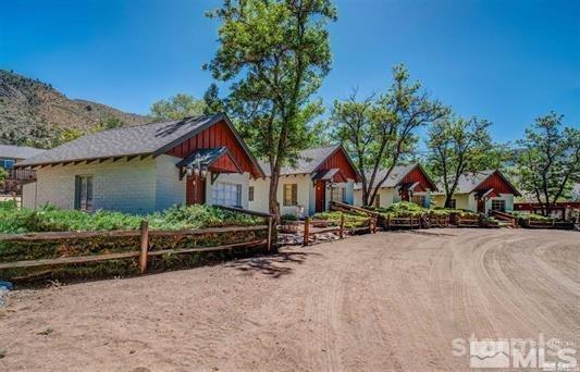 a view of a house with wooden fence