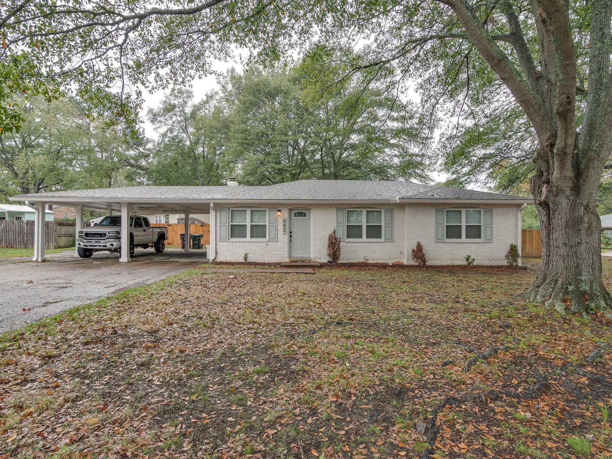 Ranch-style home featuring a carport