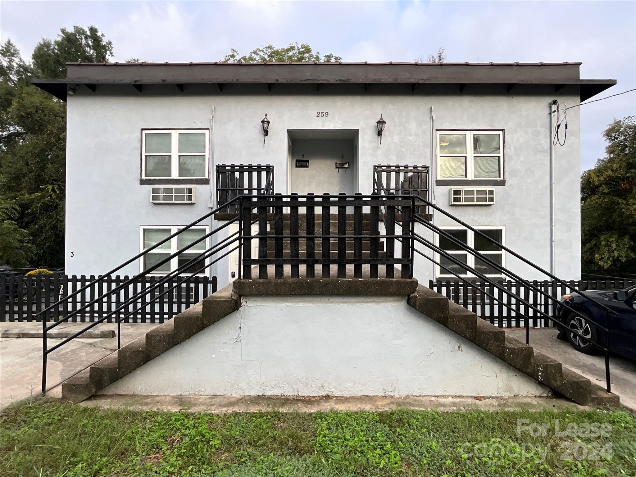 a view of a house with wooden fence