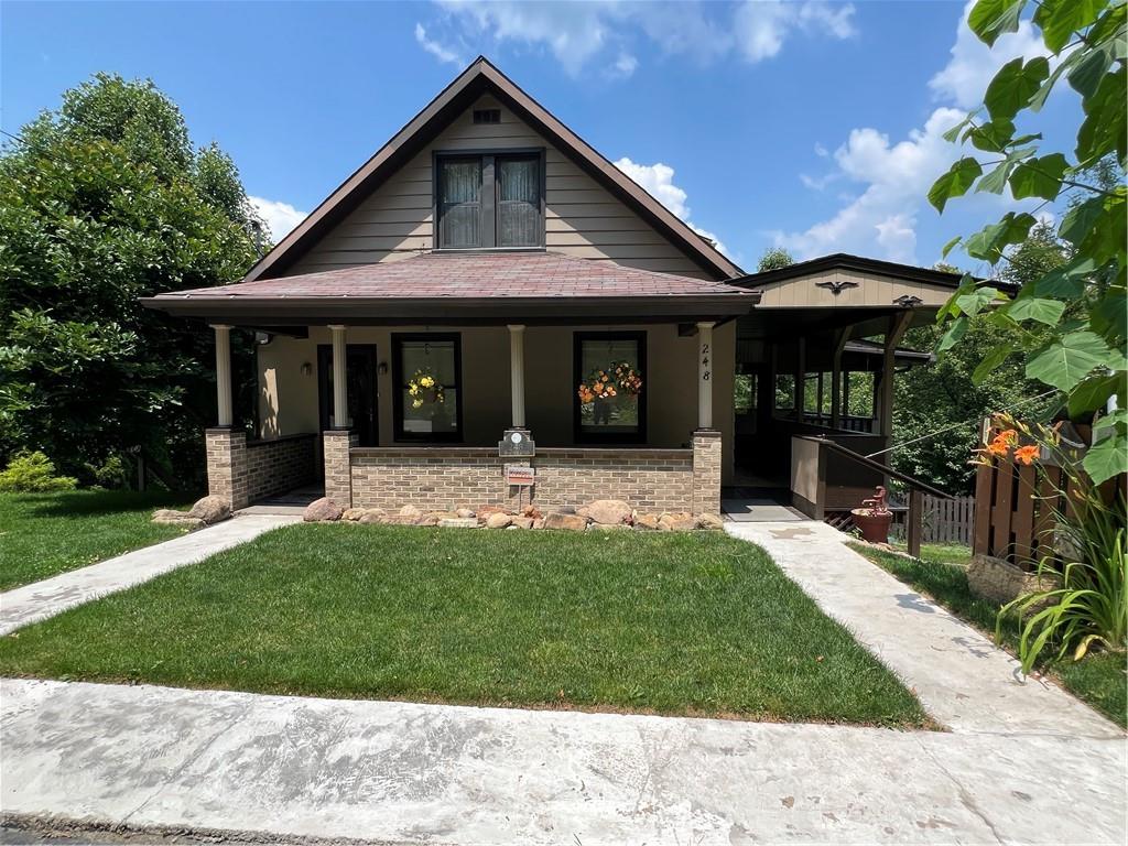 a front view of a house with a garden