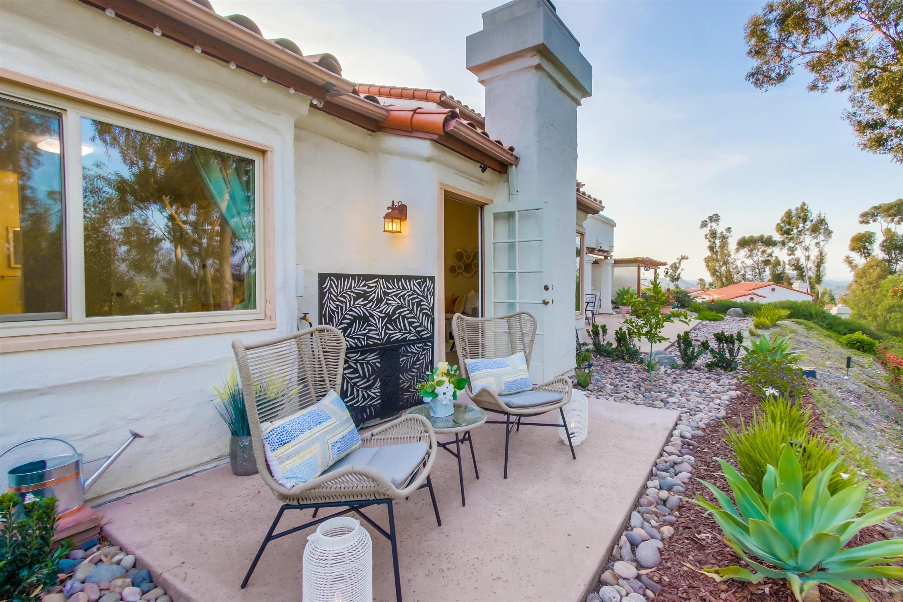 a view of a patio with a chairs and table in a patio