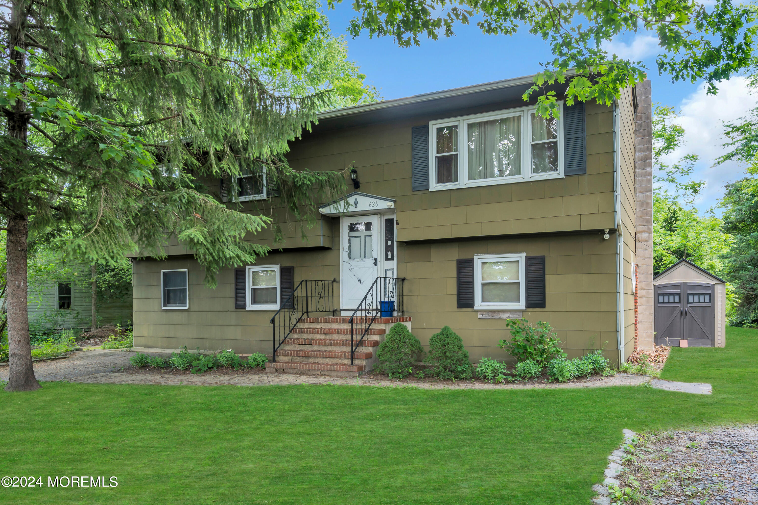 a front view of a house with a garden