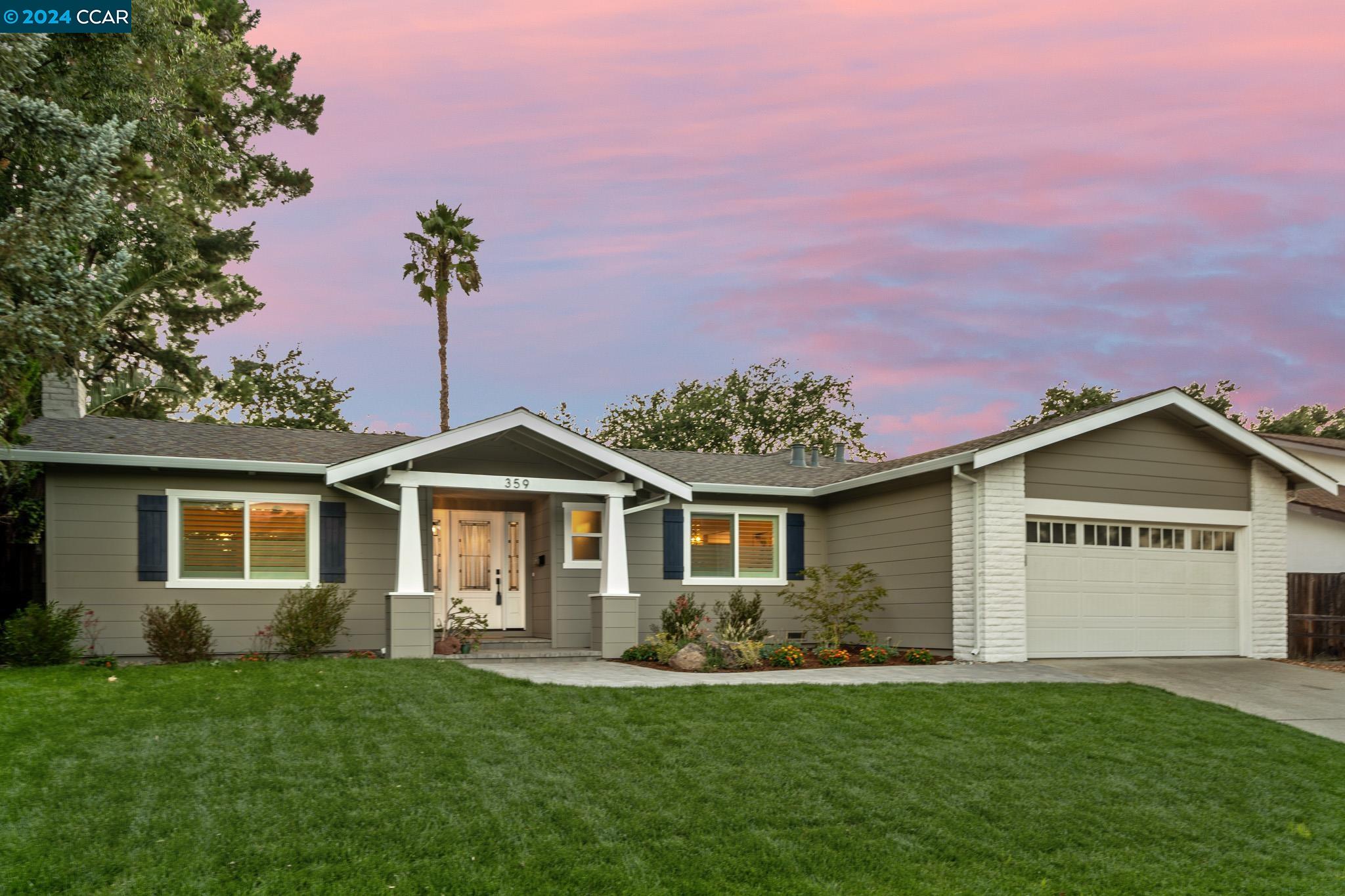 a front view of a house with a garden