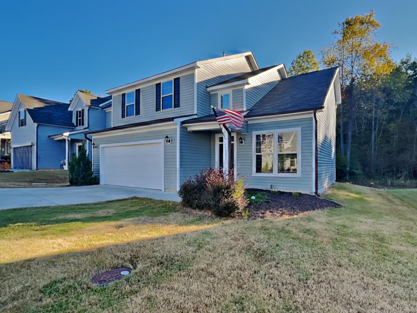 a view of a house with a yard and garage