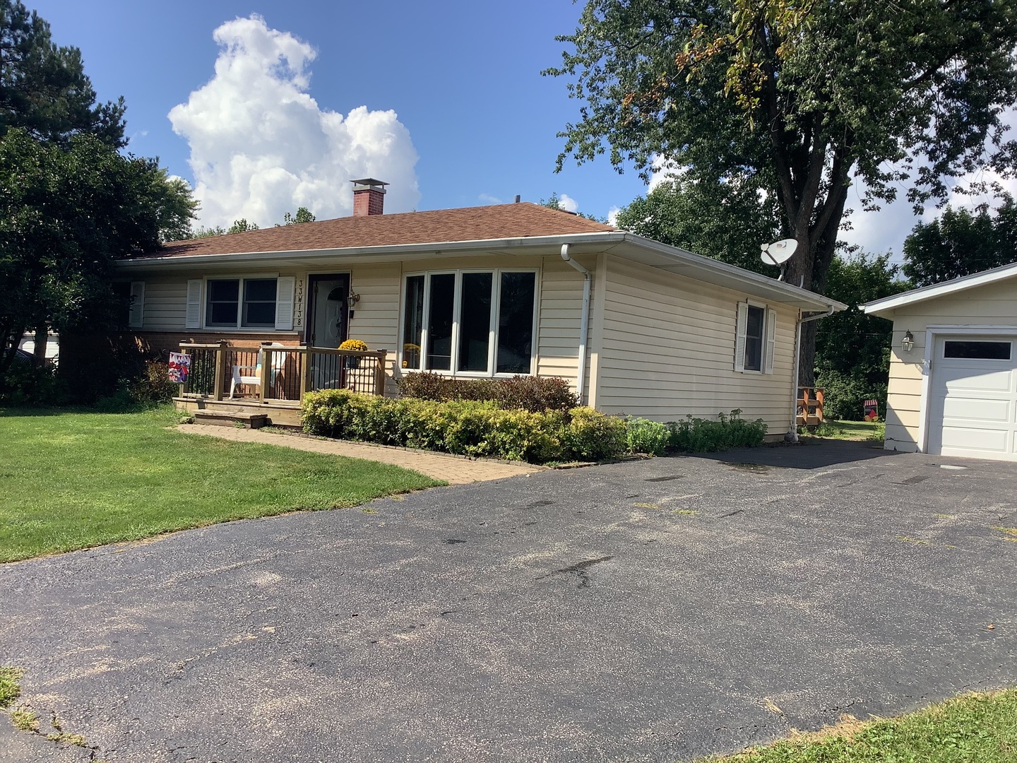 a front view of house with yard and green space