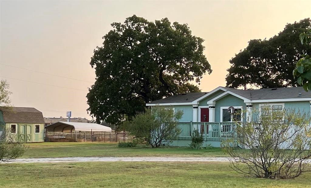 a front view of a house with a garden and plants