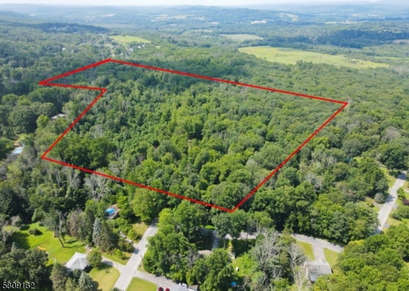 an aerial view of a houses with a green yard