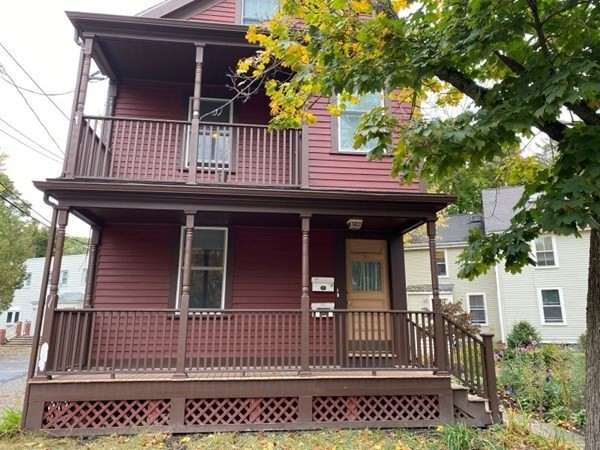 a view of a house with wooden fence