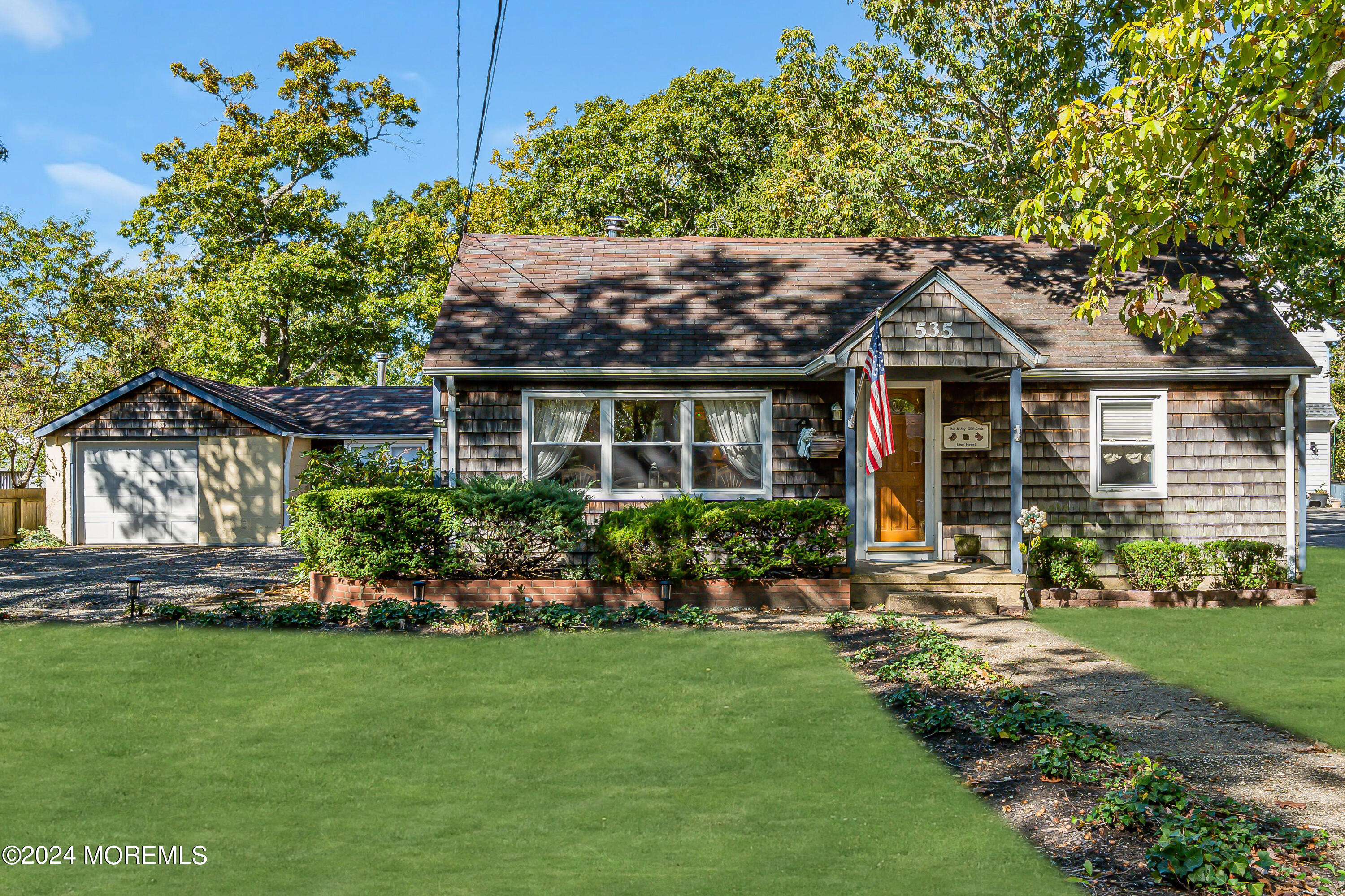 a front view of a house with a garden and plants