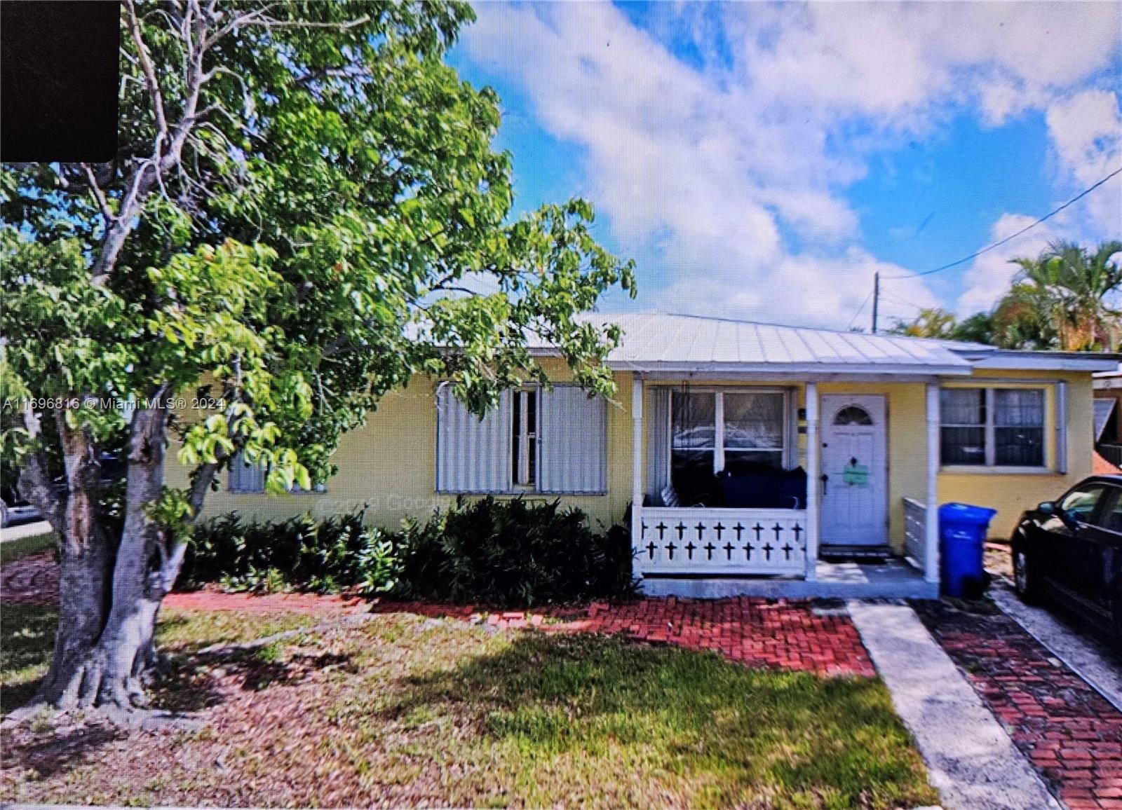 a front view of a house with yard and patio