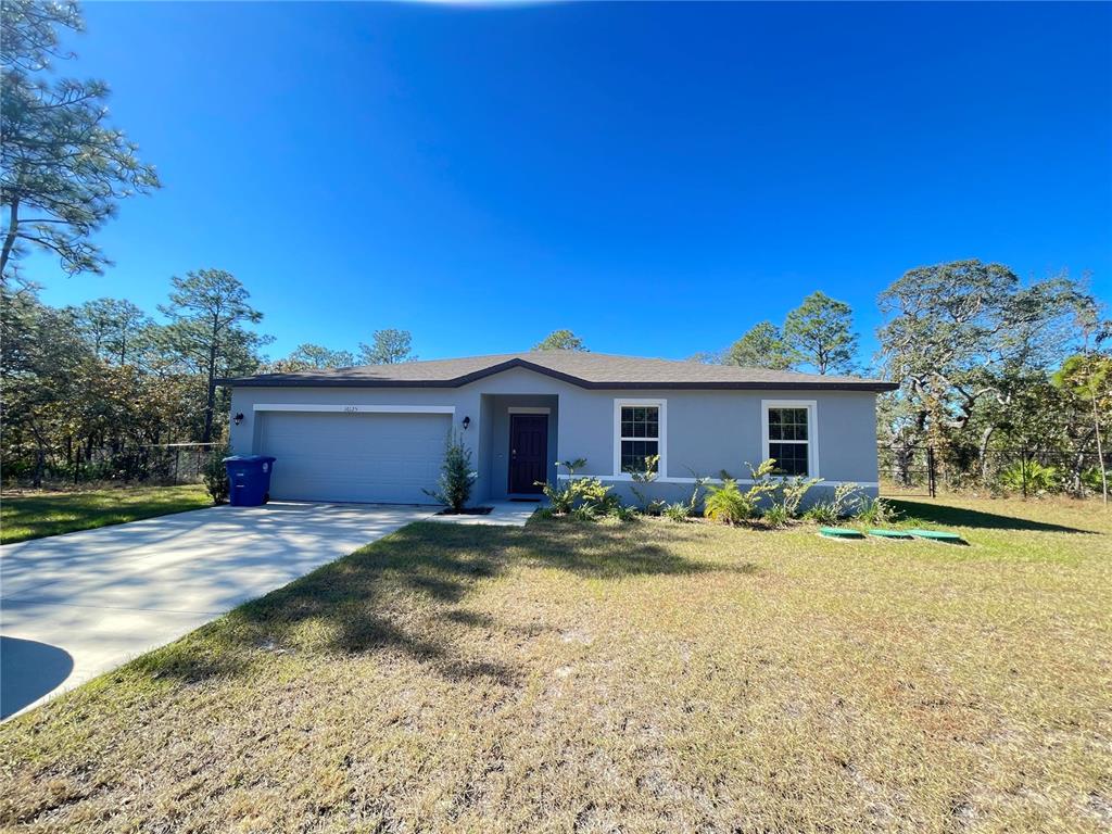 Curbside photo of your new home with a large lot and a fenced in backyard.