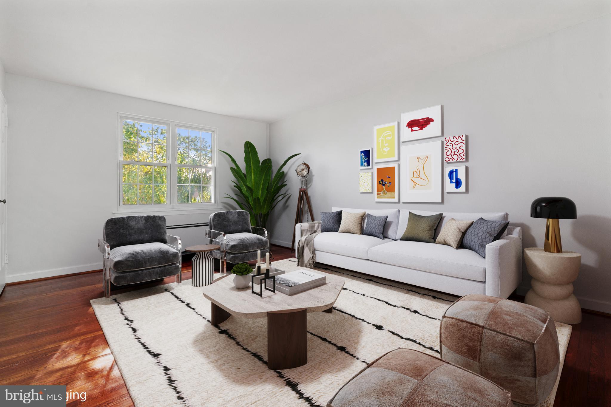 a living room with furniture and a potted plant