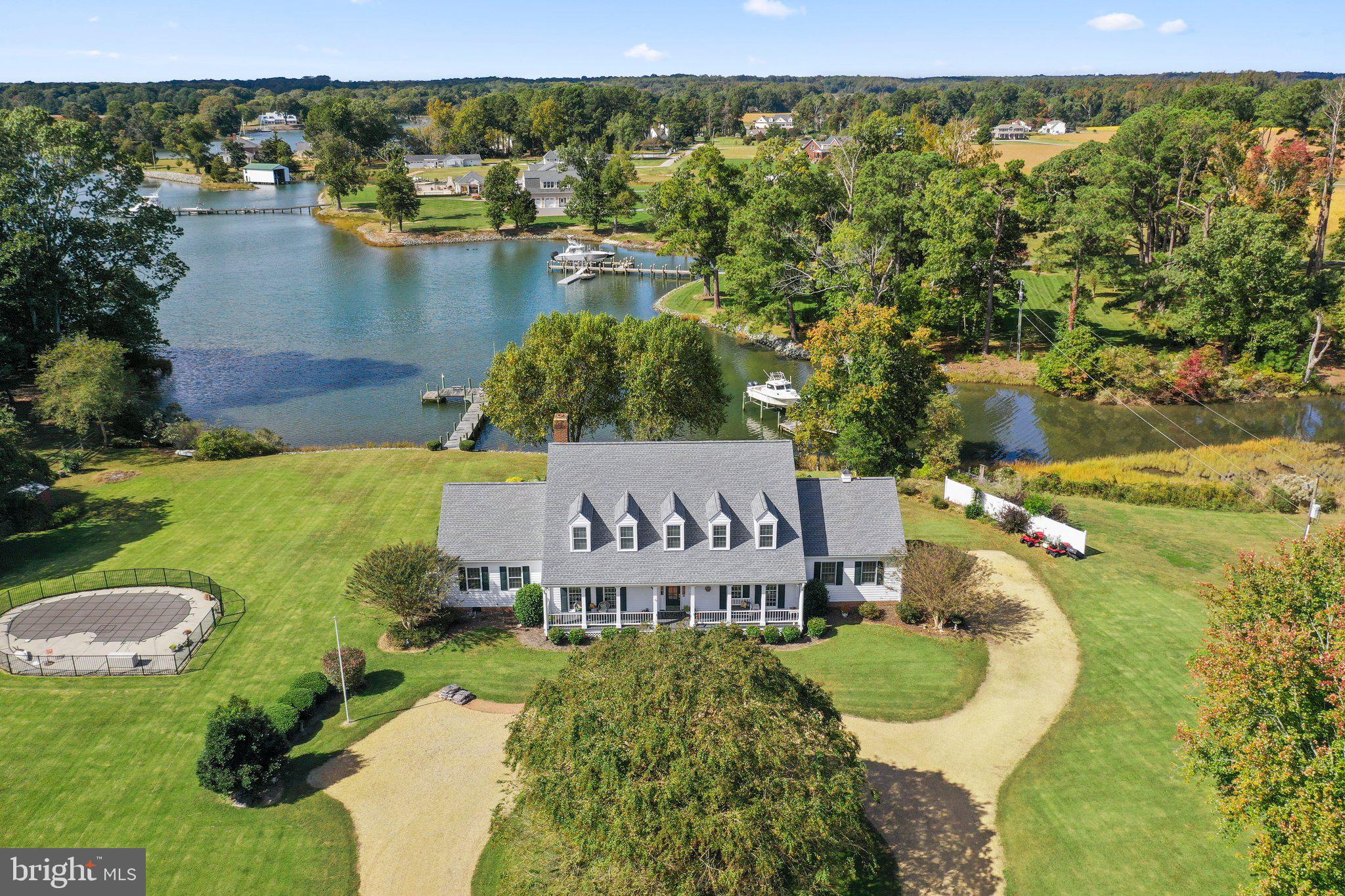 an aerial view of a house with a garden and lake view