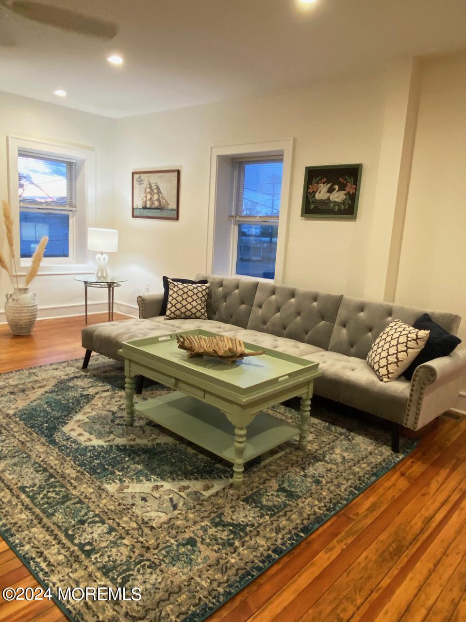 a living room with furniture and a rug