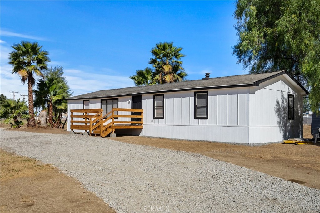 a view of a house with a patio and a yard