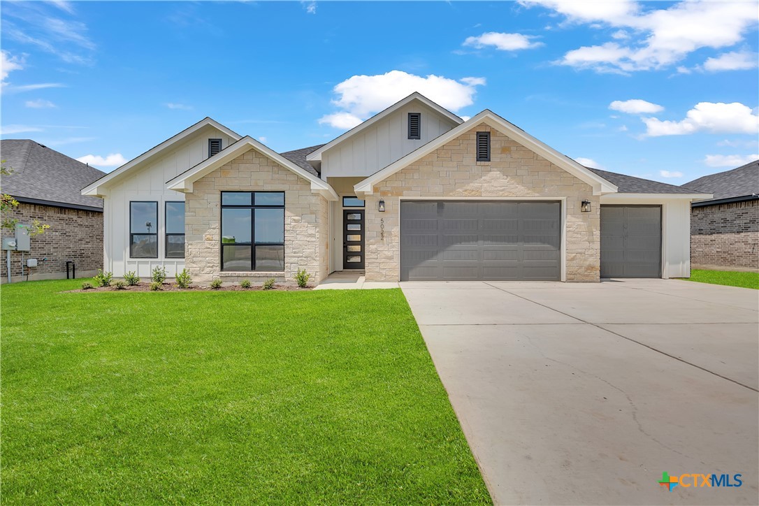 a front view of house with yard and green space