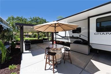 a view of a patio with table and chairs under an umbrella