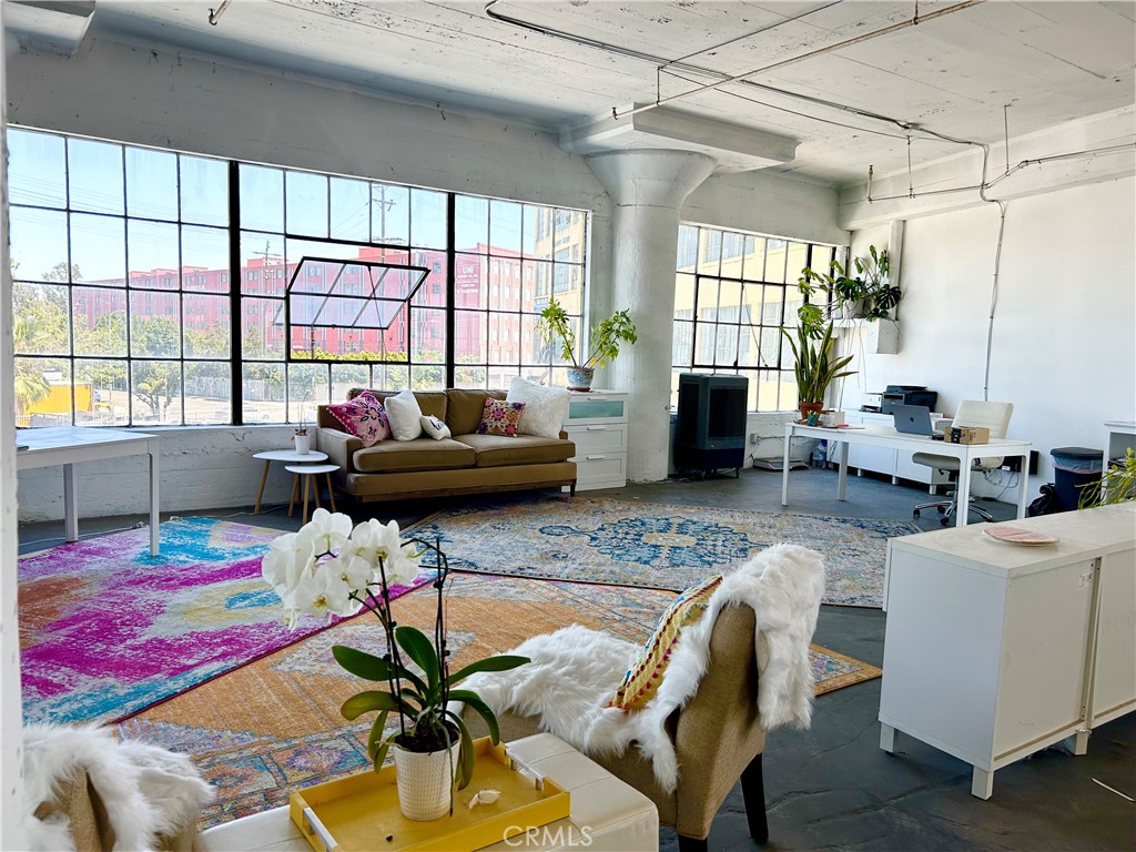 a living room with furniture and a floor to ceiling window