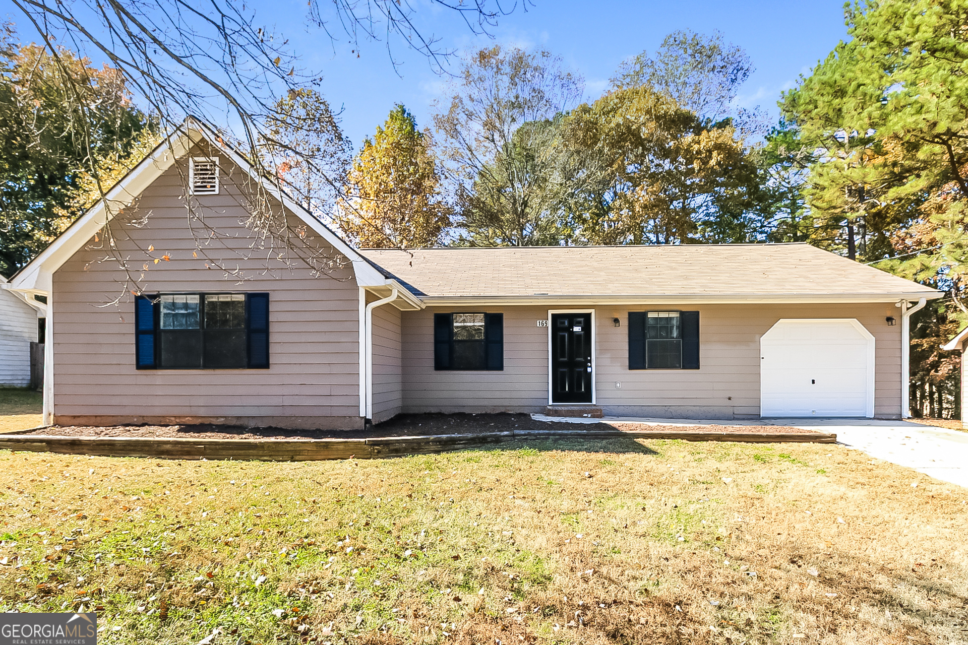 a view of house with backyard