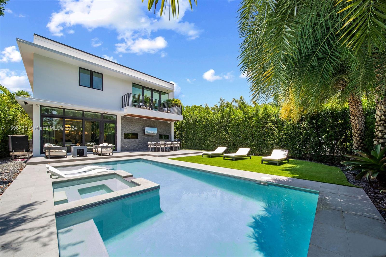 a view of an house with swimming pool and chairs