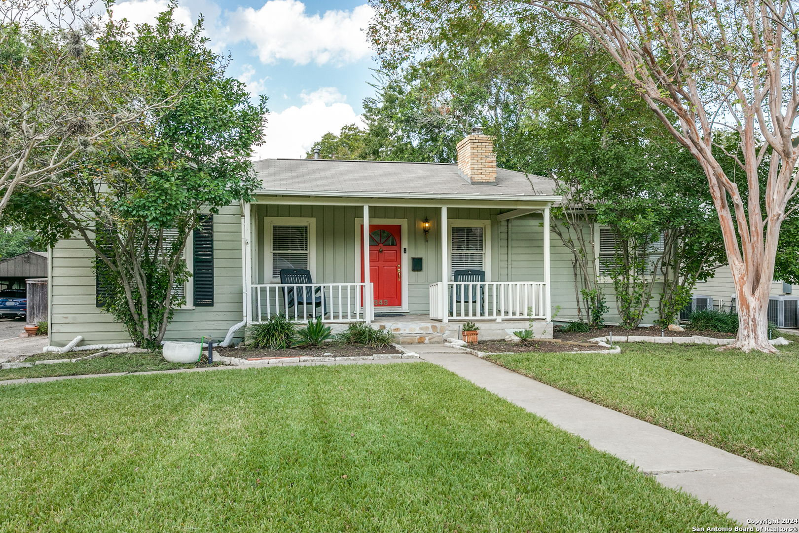 a view of a house with a yard and plants