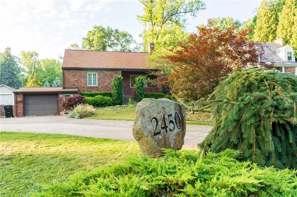 a view of a house with pool and garden