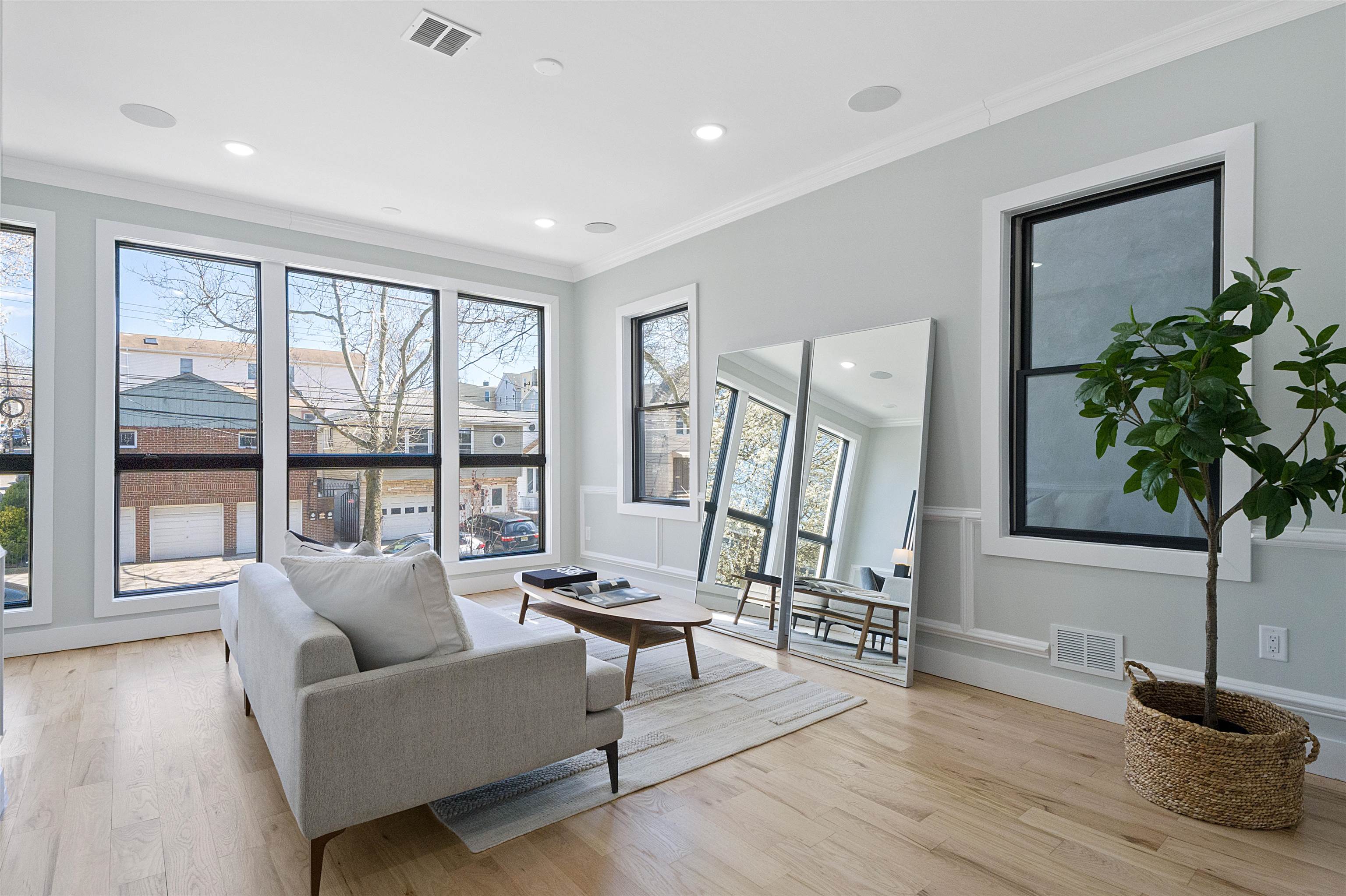 a living room with furniture and a potted plant