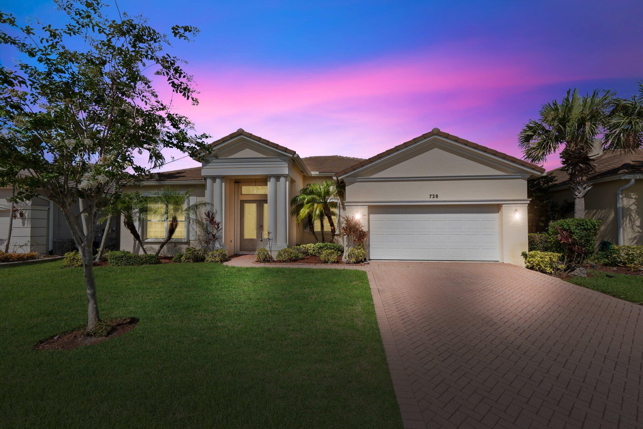 a front view of a house with a garden